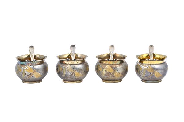 A set of four Victorian parcel gilt silver salts, each of circular form, having a wavy rim, decorated with dragonflies in the aesthetic movement taste