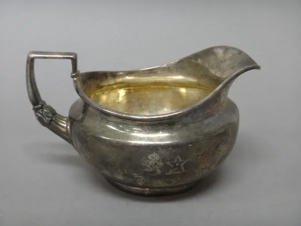 A George III silver milk jug, of circular form, in the classical taste, having an angular handle, London 1810, weight 225 gms.