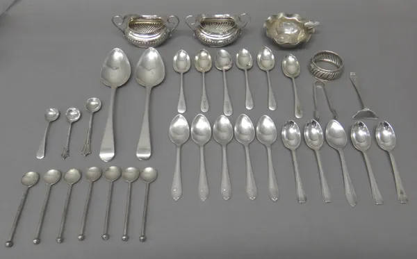 Silver, comprising; a pair of twin handled salts, with partly fluted decoration, Birmingham 1911, a napkin ring, a pair of sugar tongs, a baby's pushe