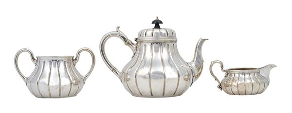 A silver composite three piece tea set, each piece of squat circular form, with fluted decoration, the teapot and the twin handled sugar bowl, London