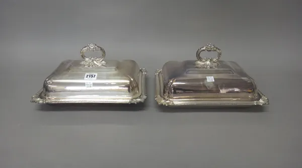 Four similar plated on copper Victorian entree dishes and covers, each base decorated with scrolling corners, each cover having an integral cast handl