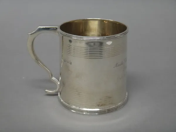 A silver christening mug of tapering cylindrical form, decorated with reeded bands, presentation inscribed, Birmingham 1926, height 8 cm, weight 179 g