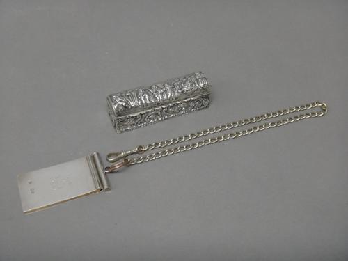 A silver rectangular hinge lidded ring box, opening to reveal slots for six rings, the exterior decorated with Dutch style figures to the hinged domed