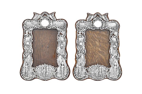 A pair of late Victorian silver mounted photograph frames, each of shaped rectangular form, decorated with Boer War scenes, by John & William Deakin,