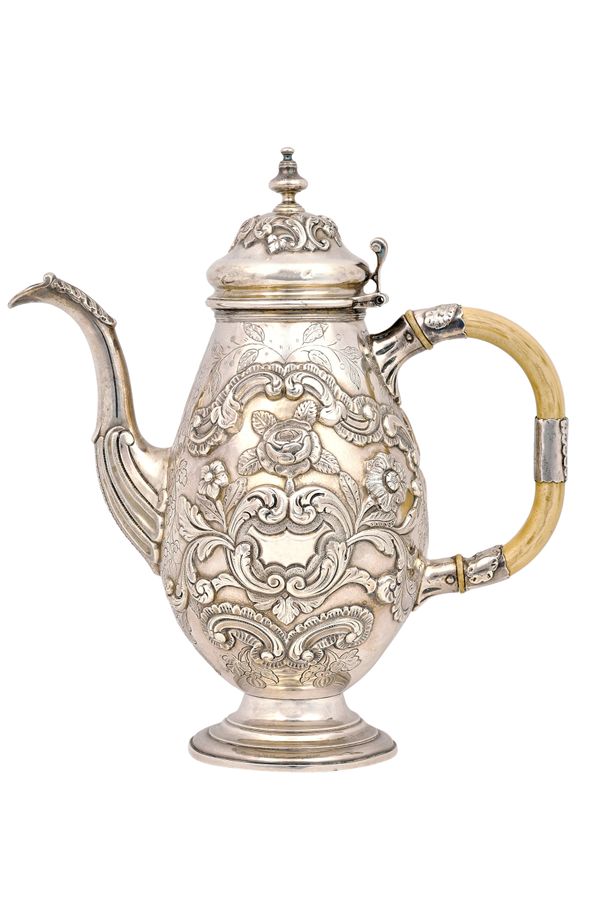 A Portuguese silver coffee pot, of bold oval form, with embossed and chased floral, foliate and scrolled decoration, raised on a circular foot, probab