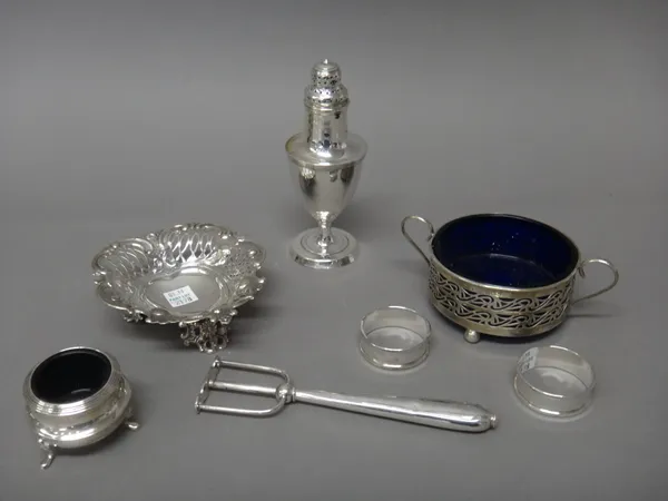 Silver and silver mounted wares, comprising; a cartouche shaped bon bon dish raised on three pierced feet, London 1896, a bread fork, two napkin rings