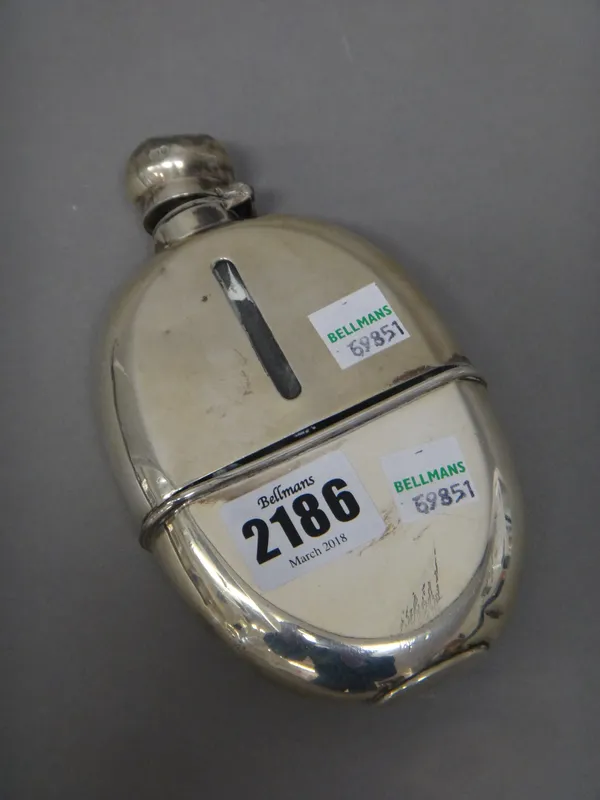 A silver mounted oval glass sprit flask, with a pull off beaker base, London 1910.