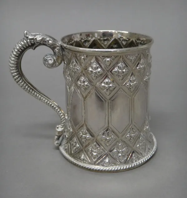 A Victorian silver christening mug, the body decorated with lozenge shaped floral panels, with a serpentine handle and with a cable rim to the base, i