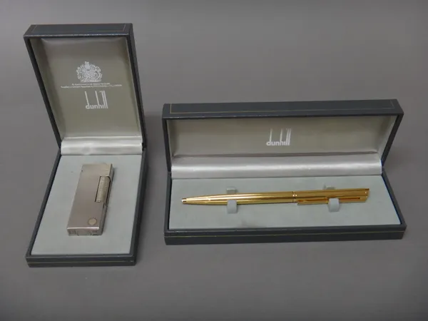 A Dunhill silver plated rectangular gas lighter, with engine turned decoration, with a Dunhill case and a Dunhill Germany gold plated ball point pen,