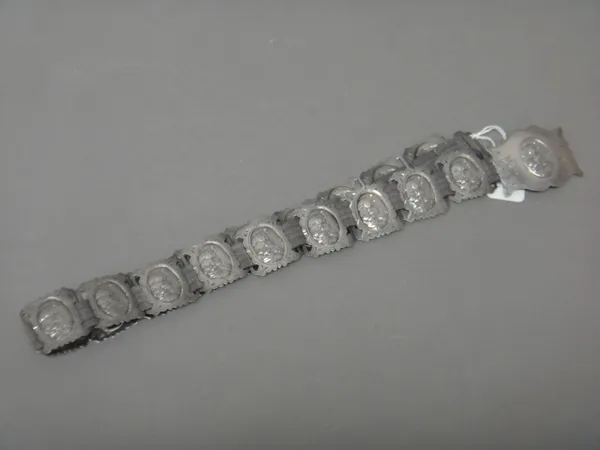 An Edwardian lady's silver waist belt, made from joined pierced and shaped rectangular panels, decorated with Art Nouveau inspired portraits of ladies