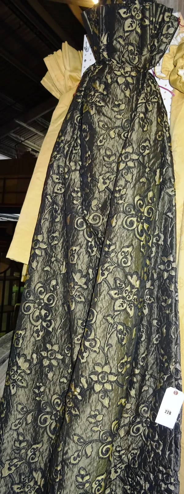 A pair of black and gold floral curtains, lined and interlined, 135cm wide x 220cm drop, (2).  J6