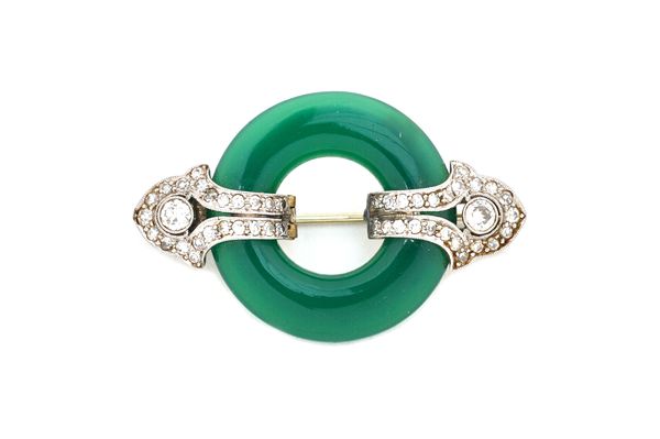 A diamond and dyed green chalcedony brooch, in an Art Deco design, 3.6cm wide, gross weight 7.1 gms.  Illustrated