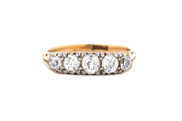 A gold and diamond set five stone ring, mounted with a row of cushion shaped diamonds, graduating in size to the centre stone, the mount decorated wit