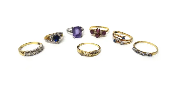 An amethyst and diamond ring, claw set with the cut cornered rectangular step cut amethyst between diamond set four stone shoulders, a gold, ruby and