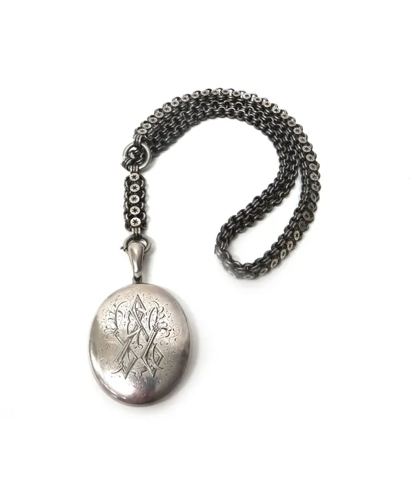 A Victorian oval pendant locket, with engraved decoration to one side and monogram engraved to the other side, fitted to a multiple link collar chain