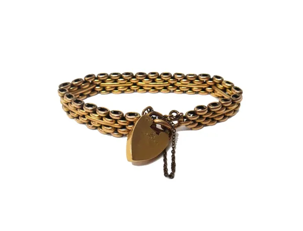 A gold bar and oval link stylised gate bracelet, detailed 18 ct on an 18 ct gold heart shaped padlock clasp, Birmingham 1907, fitted with a base metal