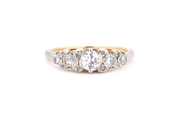 A gold and diamond set half hoop ring, mounted with five principal cushion shaped diamonds, graduating in size to the centre stone and with four pairs