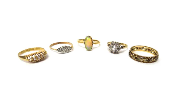 A gold ring, claw set with an oval opal, an 18ct gold and diamond set five stone ring, a gold and platinum, diamond set single stone ring, a 9ct gold