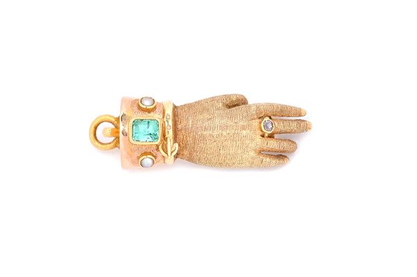 A predominantly 19th century gold, emerald and half pearl set brooch clasp, designed as a hand wearing a diamond ring, the later cuff mounted with a s