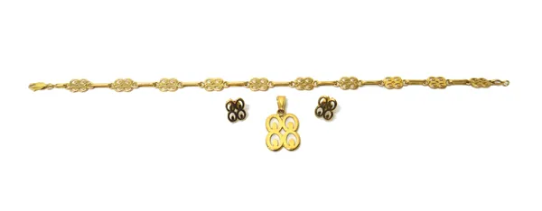 A gold bracelet, in a pierced scroll panel link design, on a sprung hook shaped clasp, detailed 750, with a pendant and a pair of earstuds, the backs