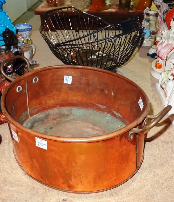A silver plated basket with swing-over handle, and a copper twin handled pan, (2).  S3