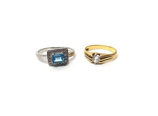 A gold and diamond set single stone ring, claw set with a cushion shaped diamond, detailed '18ct', ring size P and a 9ct white gold, blue topaz and di