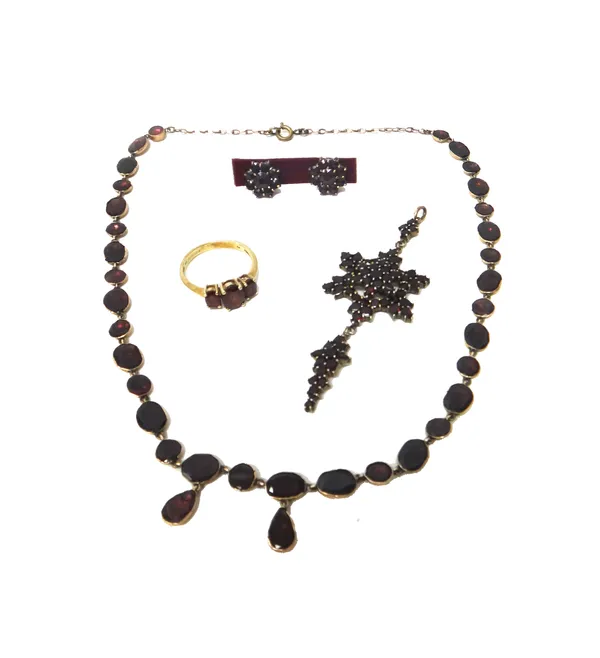 A flat cut garnet set necklace, a Bohemian garnet set pendant, in a hexagonal design, a 9ct gold and garnet set three stone ring, mounted with oval cu