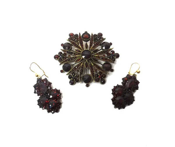 A pair of garnet set pendant earrings, each mounted with a pear shaped garnet above the three principal circular cut garnets and a Bohemian garnet set