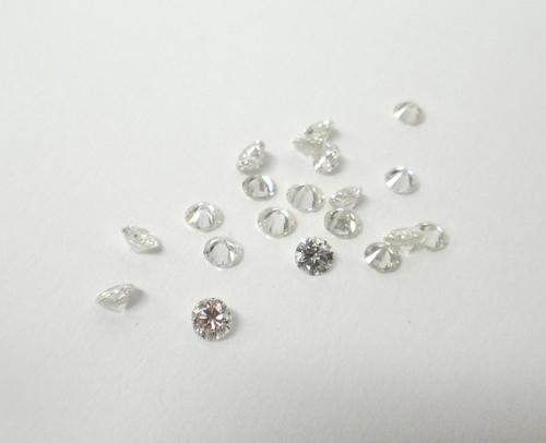 A group of unmounted diamonds, comprising; one circular cut diamond weighing approx 0.50 cts and twenty smaller circular cut diamonds, combined total