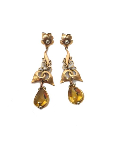 A pair of gold and citrine pendant earrings, each with a pear shaped citrine drop and with a flowerhead shaped surmount, the tops having post and butt