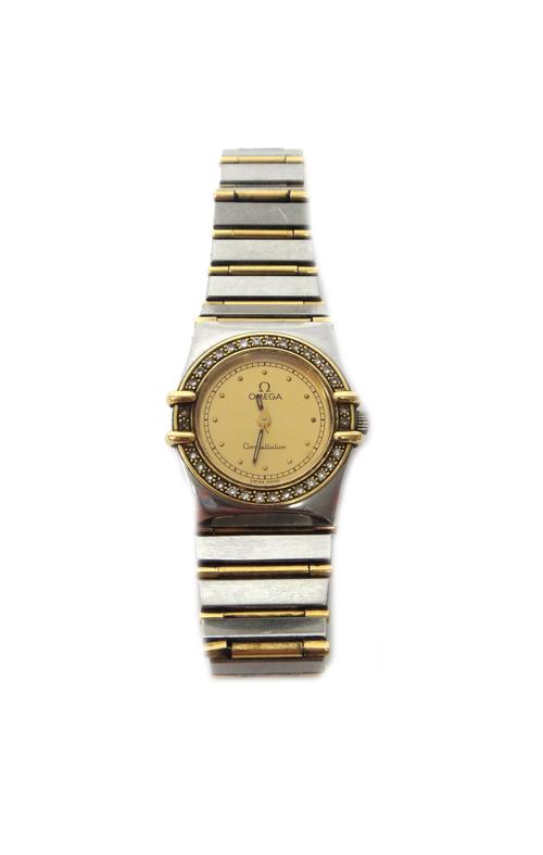 A lady's stainless steel and diamond set Omega Constellation bracelet wristwatch, the signed gilt dial having gilt dot numerals and with a surround of