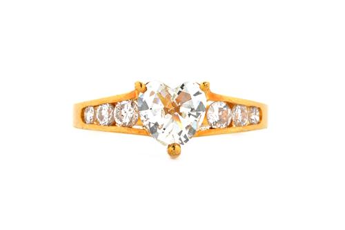 A gold and diamond set ring, claw set with the principal heart shaped diamond to the centre, between diamond set three stone tapered shoulders, mounte