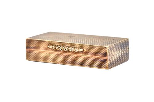 A 9ct gold rectangular hinge lidded pill box, the exterior with engine turned decoration, London 1973, size 4cm x 2cm, weight 19 gms.  Illustrated