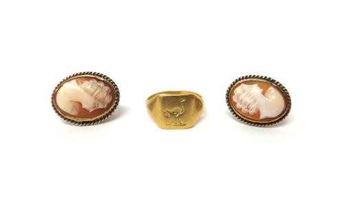 A gold signet ring, seal engraved with a bird crest, unmarked, weight 4.1 gms, ring size L and a half and a pair of gold mounted oval shell cameo ears