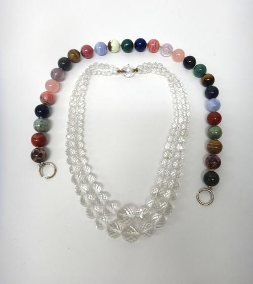 A two row necklace of graduated spherical rock crystal beads, on a rock crystal bead clasp and a single row necklace of vary coloured hardstone beads
