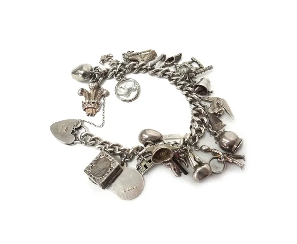 A silver curb link charm bracelet, with a silver heart shaped padlock clasp, fitted with a variety of mostly silver charms, a faceted curb link neckch