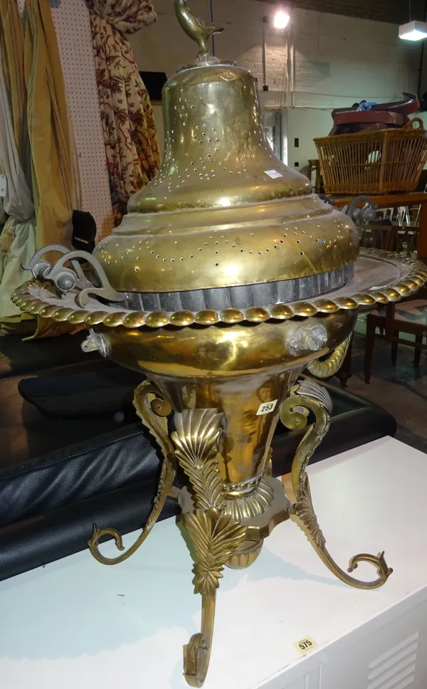 A 20th century brass urn on four scrolling legs, 52cm high. F5