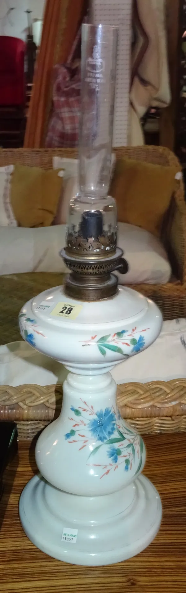 A Dutch ceramic oil lamp painted with a blue floral decoration, 59cm high.  G5