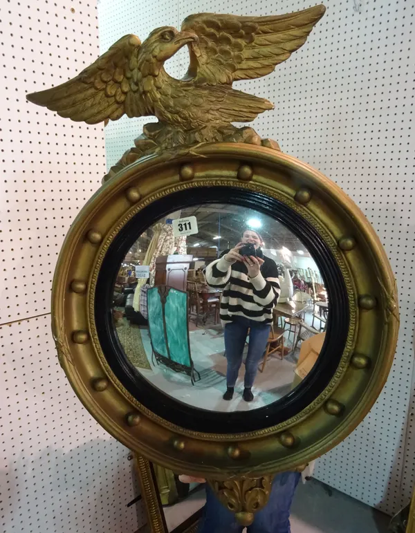 A gilt convex wall mirror, 45cm wide.  A4