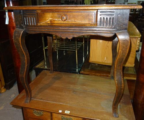 An early 20th century Continental oak single drawer side table, on double cabriole supports, 74cm wide x 69cm high. I9