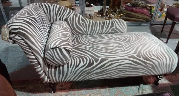 A 20th century chaise longue, with zebra print upholstery, on metal scroll supports.  C4