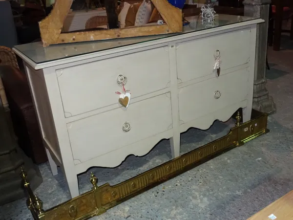 A 20th century white painted sideboard, with four short drawers, on square tapering supports, 150cm wide x 86cm high.  H4