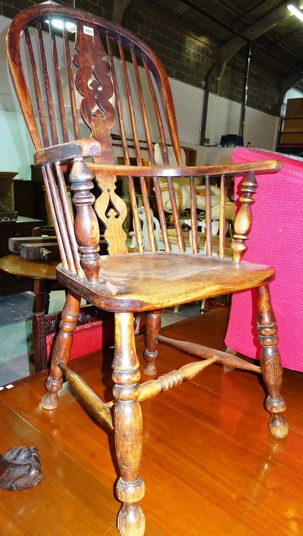A 19th century ash and elm stick back Windsor open armchair.  F6