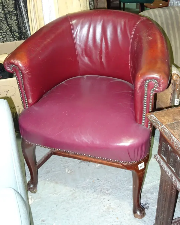 A Victorian mahogany framed tub back armchair, with red leather upholstery, on pad feet.  J5