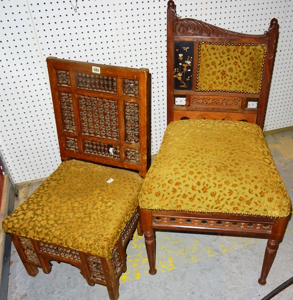 An early 20th century walnut library style low chair, with spindle decoration, together with a hardwood hall chair, with carved top rail and fret cut
