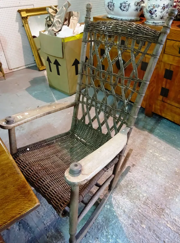 An early 20th century pine rocking chair, with wicker seat and back.  C4