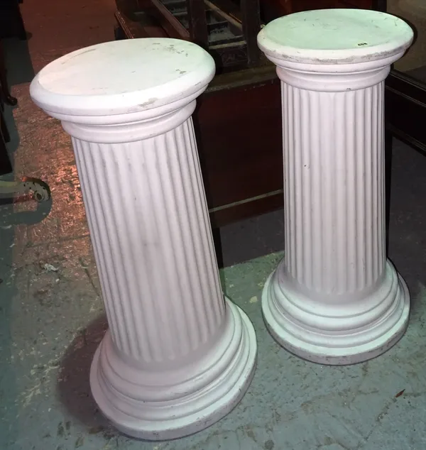 A pair of 20th century white painted faux marble columns, 34cm wide x 84cm high, (2).  I4