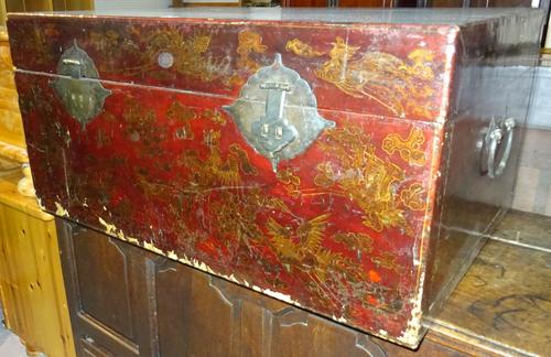 An early 20th century red lacquer chinoiserie decorated trunk, 98cm wide x 48cm high.  K8