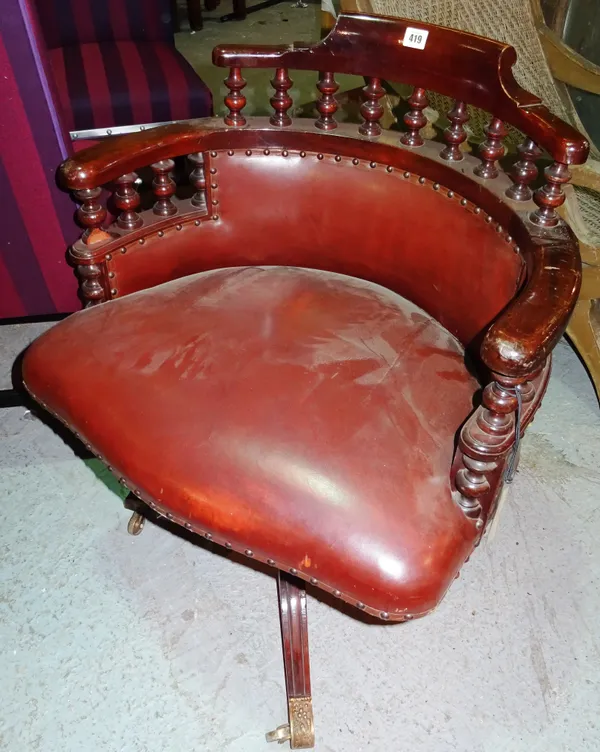A Victorian mahogany framed office swivel armchair, with spindle back, on a tripod base.  G4
