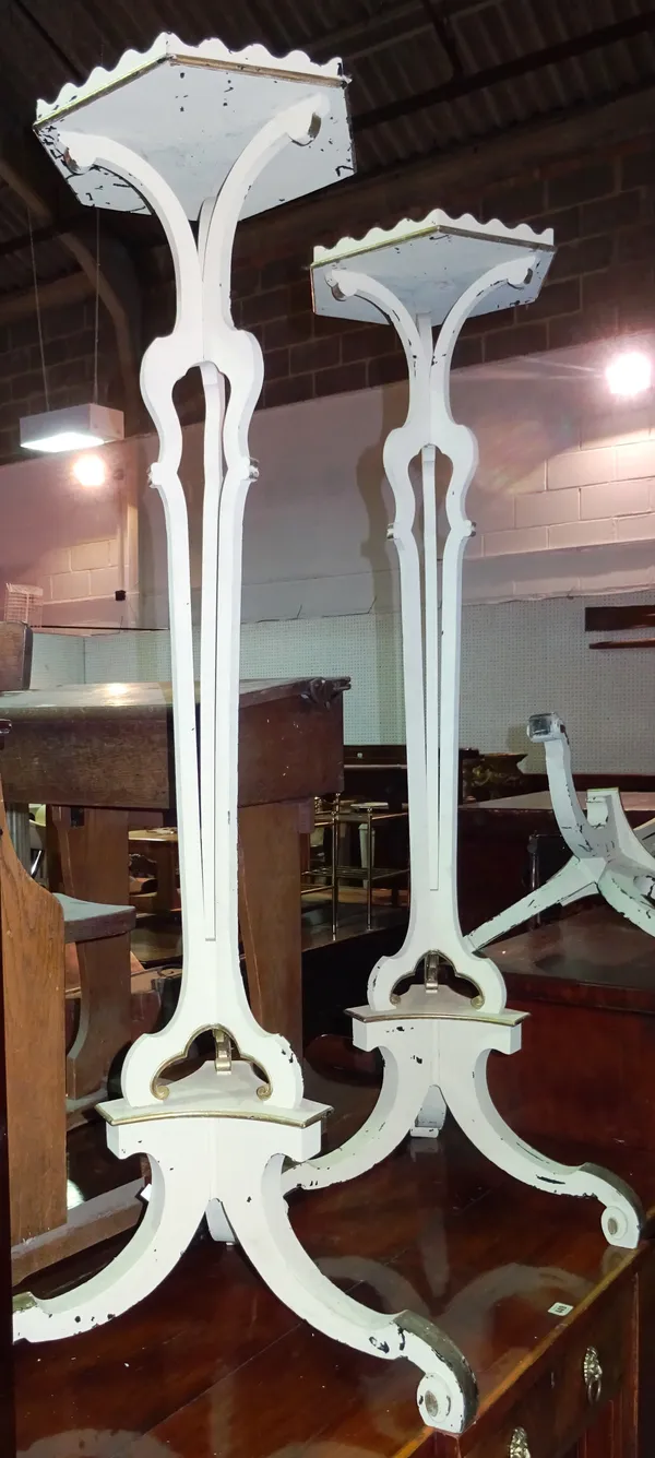 A pair of cream painted Continental style torchere stands, each with hexagonal top and three central columns, on scroll supports, 35cm wide x 145cm hi